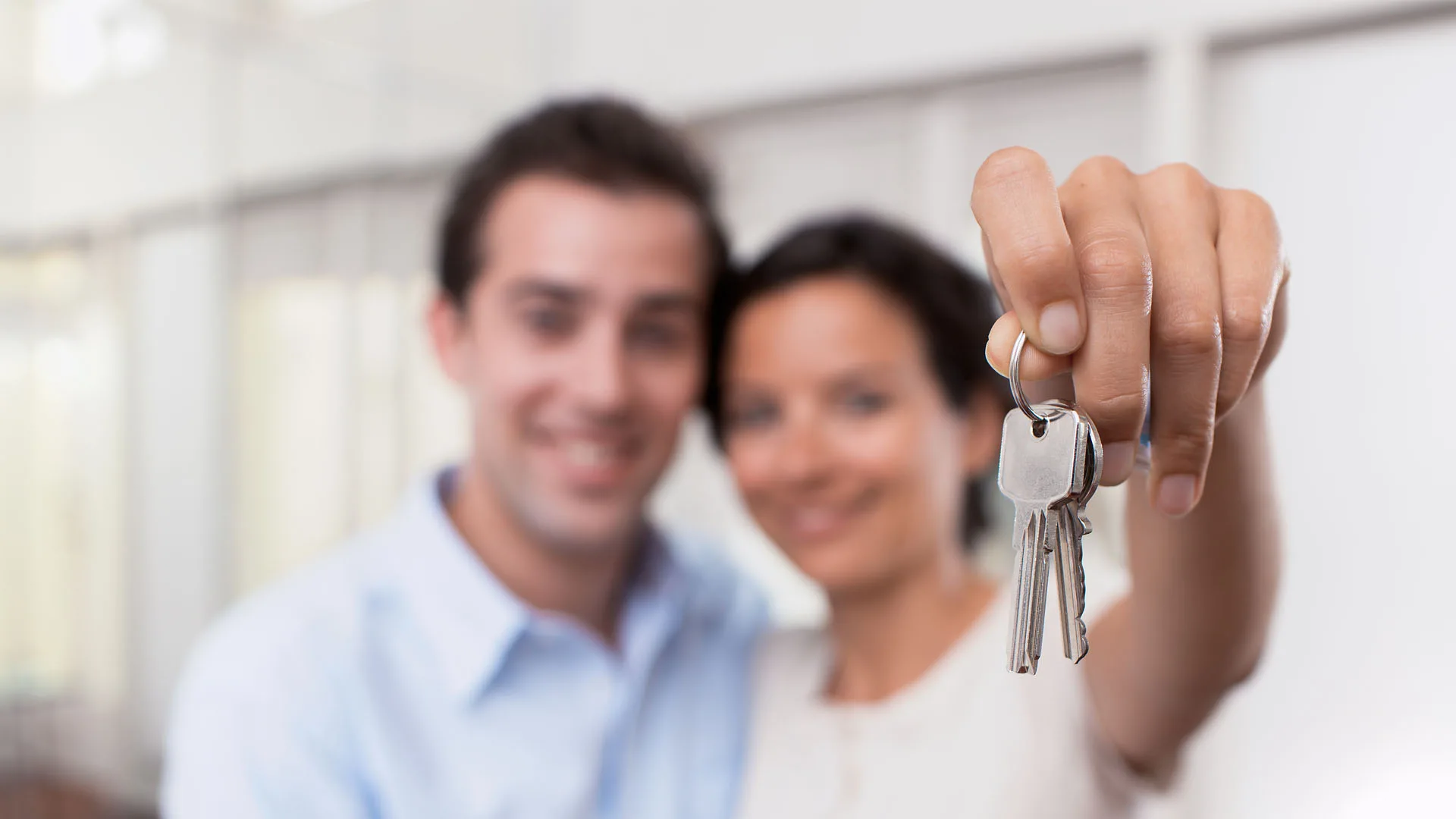 couple holding keys to new WDL house